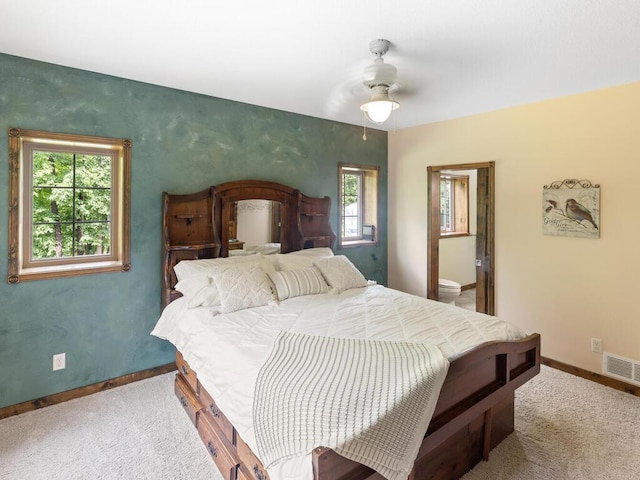 2406 Augusta Rd, Fair Haven Twp, MN 55382 - carpeted bedroom with multiple windows, ceiling fan, and ensuite bathroom