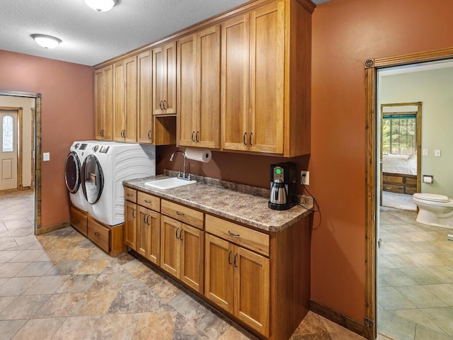 2406 Augusta Rd, Fair Haven Twp, MN 55382 - laundry room with washing machine and dryer, cabinet space, and a textured ceiling
