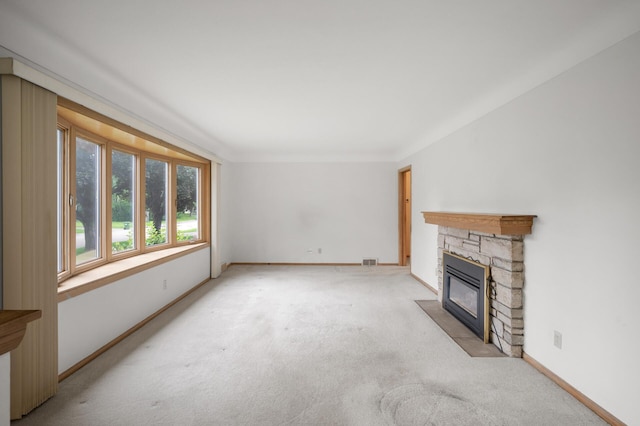 1306 Ryan Ave W, Roseville, MN 55113 - unfurnished living room featuring light carpet and a stone fireplace