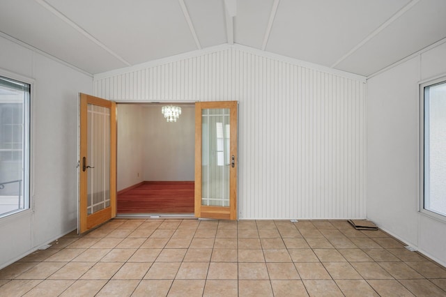 1306 Ryan Ave W, Roseville, MN 55113 - unfurnished room featuring vaulted ceiling, plenty of natural light, and a chandelier