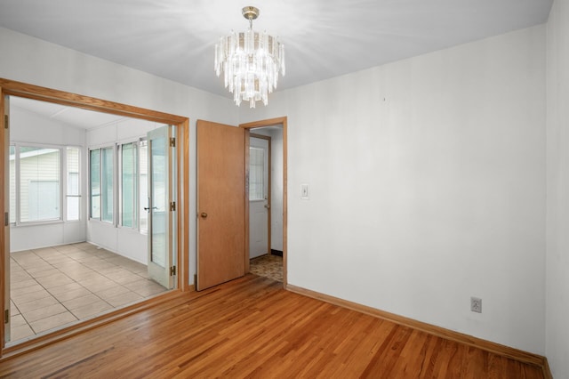 1306 Ryan Ave W, Roseville, MN 55113 - unfurnished room with a chandelier and light wood finished floors