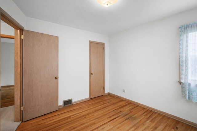 1306 Ryan Ave W, Roseville, MN 55113 - unfurnished bedroom with light wood-style floors and baseboards