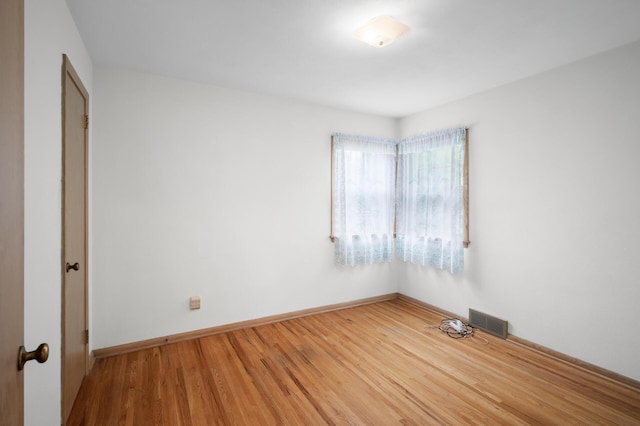 1306 Ryan Ave W, Roseville, MN 55113 - spare room featuring wood finished floors and baseboards