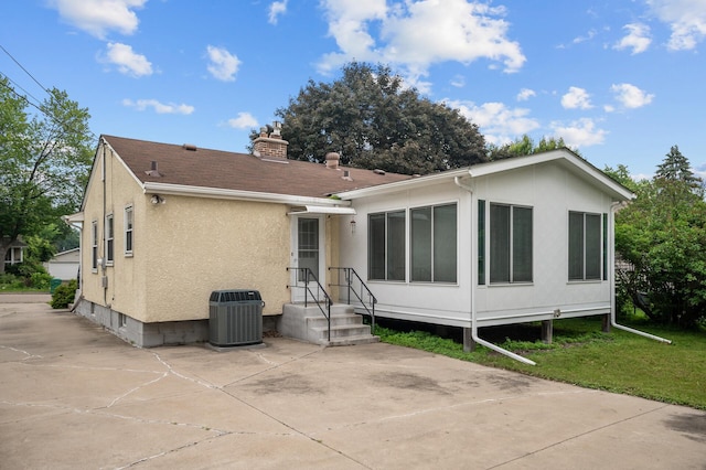 1306 Ryan Ave W, Roseville, MN 55113 - back of property with a chimney, stucco siding, and a yard