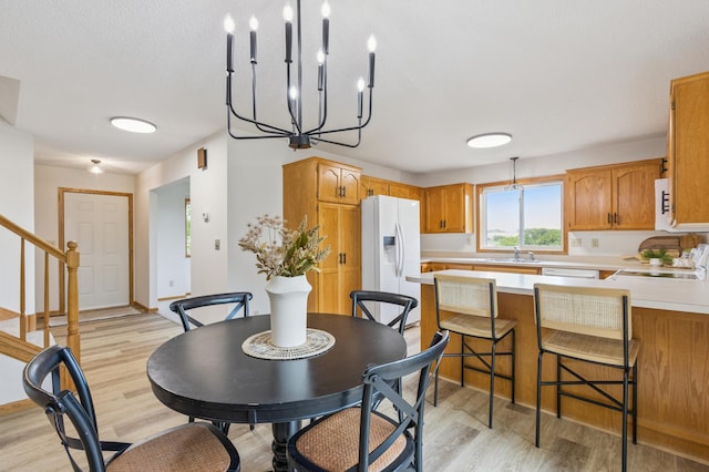 11817 51st St NE, Albertville, MN 55301 - dining room featuring light wood-style flooring, stairs, and a chandelier