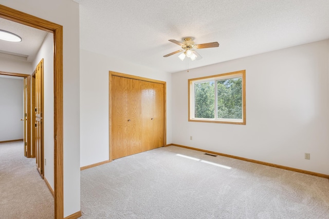 11817 51st St NE, Albertville, MN 55301 - unfurnished bedroom with carpet floors, a closet, ceiling fan, and a textured ceiling