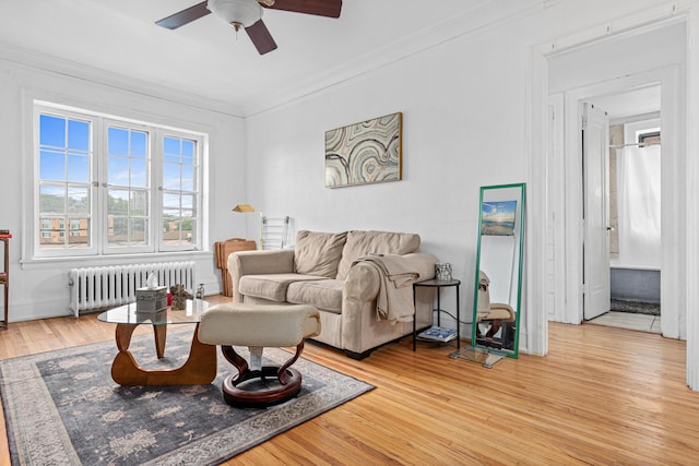 1820 1st Ave S Unit 208, Minneapolis, MN 55403 - living area with radiator, a ceiling fan, ornamental molding, and wood finished floors