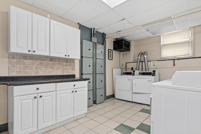 1820 1st Ave S Unit 208, Minneapolis, MN 55403 - washroom featuring separate washer and dryer, cabinet space, and light tile patterned floors