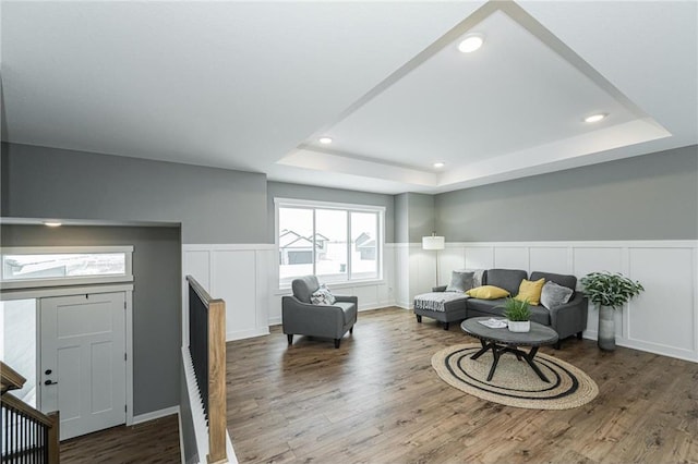 2105 Elk Run Dr SE, Pine Island, MN 55963 - living room with a raised ceiling, a decorative wall, wood finished floors, a wainscoted wall, and recessed lighting