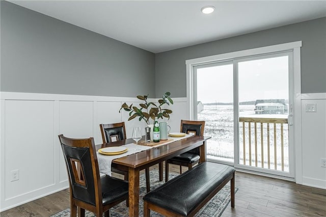 2105 Elk Run Dr SE, Pine Island, MN 55963 - dining area with a decorative wall, a wainscoted wall, and wood finished floors