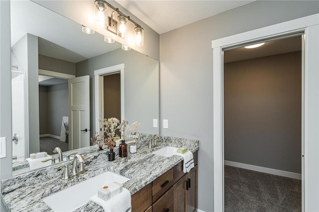 2105 Elk Run Dr SE, Pine Island, MN 55963 - bathroom with double vanity and baseboards