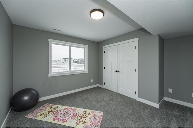 2105 Elk Run Dr SE, Pine Island, MN 55963 - unfurnished bedroom with dark carpet and a closet
