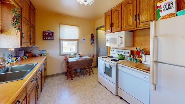 715 3rd Ave, Albert Lea, MN 56007 - kitchen with white appliances, brown cabinets, backsplash, and light countertops