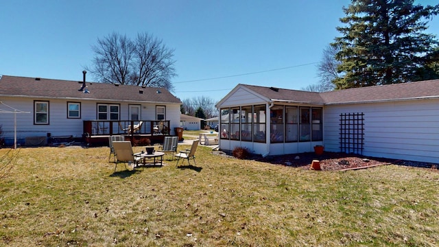 715 3rd Ave, Albert Lea, MN 56007 - view of grassy yard featuring a sunroom, a wooden deck, and an outdoor fire pit