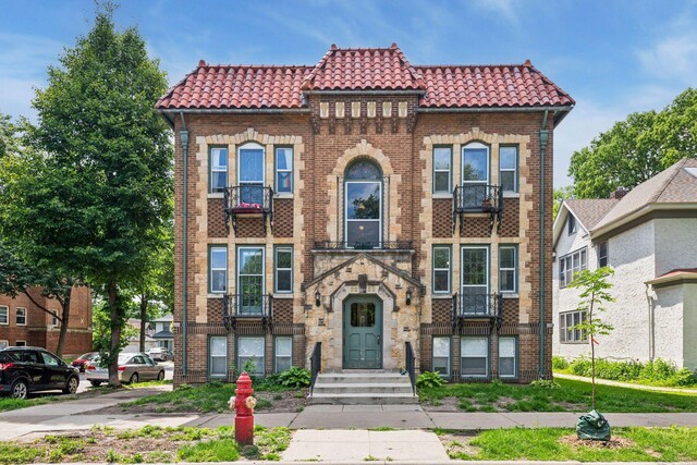 3252 Fremont Ave S Unit 102, Minneapolis, MN 55408 - view of front of house with a tiled roof and brick siding