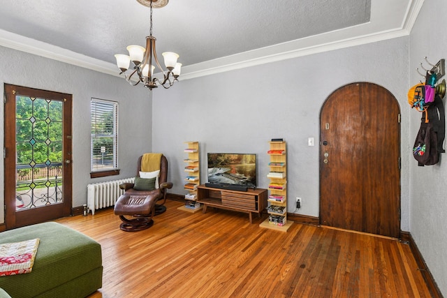 3252 Fremont Ave S Unit 102, Minneapolis, MN 55408 - living area featuring radiator heating unit, crown molding, wood-type flooring, a chandelier, and a textured wall