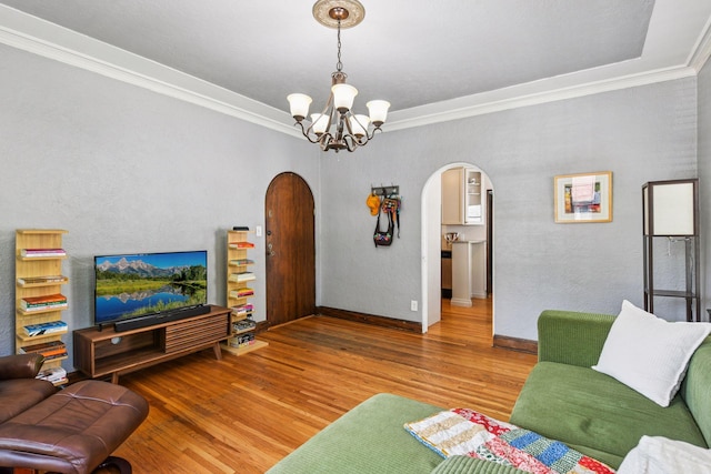 3252 Fremont Ave S Unit 102, Minneapolis, MN 55408 - living area with arched walkways, wood finished floors, a chandelier, and ornamental molding