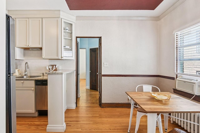 3252 Fremont Ave S Unit 102, Minneapolis, MN 55408 - kitchen with light wood-style floors, appliances with stainless steel finishes, backsplash, and cooling unit