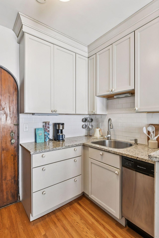 3252 Fremont Ave S Unit 102, Minneapolis, MN 55408 - kitchen featuring dishwasher, light wood-style flooring, backsplash, and light stone counters