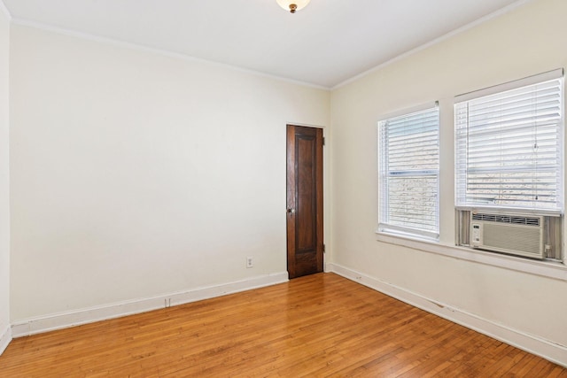 3252 Fremont Ave S Unit 102, Minneapolis, MN 55408 - spare room with ornamental molding, light wood-style flooring, and cooling unit