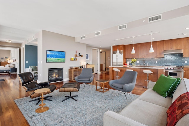 222 2nd St SE Unit 1503, Minneapolis, MN 55414 - living area featuring light wood finished floors and a glass covered fireplace