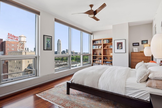 222 2nd St SE Unit 1503, Minneapolis, MN 55414 - bedroom with a skyline view, wood finished floors, and ceiling fan