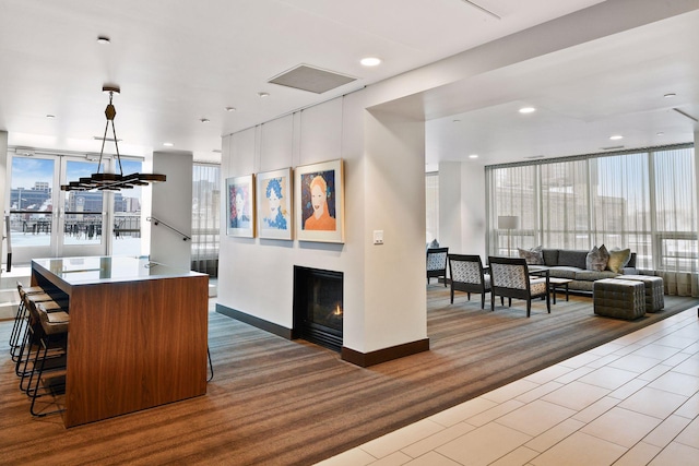 222 2nd St SE Unit 1503, Minneapolis, MN 55414 - kitchen with open floor plan, a glass covered fireplace, a center island, pendant lighting, and a breakfast bar