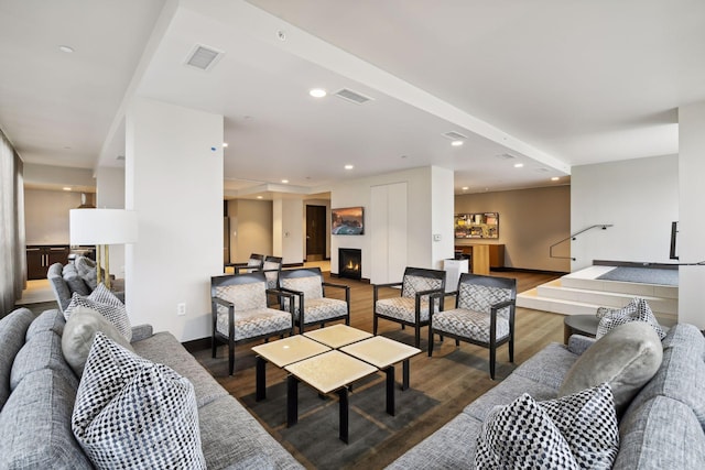 222 2nd St SE Unit 1503, Minneapolis, MN 55414 - living room featuring a warm lit fireplace, wood finished floors, and recessed lighting