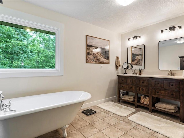 11034 Forest View Ct SW, Nisswa, MN 56468 - full bathroom featuring a freestanding tub, double vanity, a textured ceiling, and tile patterned floors