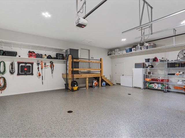 11034 Forest View Ct SW, Nisswa, MN 56468 - garage with a garage door opener and freestanding refrigerator