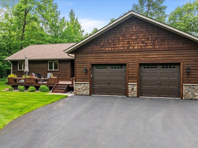 11034 Forest View Ct SW, Nisswa, MN 56468 - single story home featuring asphalt driveway, stone siding, a garage, a front lawn, and a deck