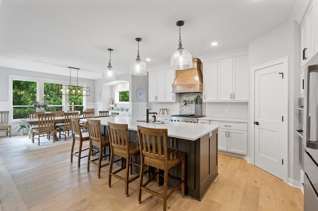 4452 167th Ave NW, Andover, MN 55304 - kitchen featuring premium range hood, light countertops, white cabinetry, and recessed lighting