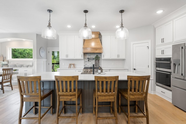 4452 167th Ave NW, Andover, MN 55304 - kitchen featuring custom exhaust hood, appliances with stainless steel finishes, light countertops, white cabinetry, and recessed lighting