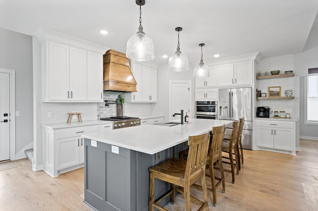 4452 167th Ave NW, Andover, MN 55304 - kitchen with appliances with stainless steel finishes, custom range hood, tasteful backsplash, white cabinetry, and recessed lighting