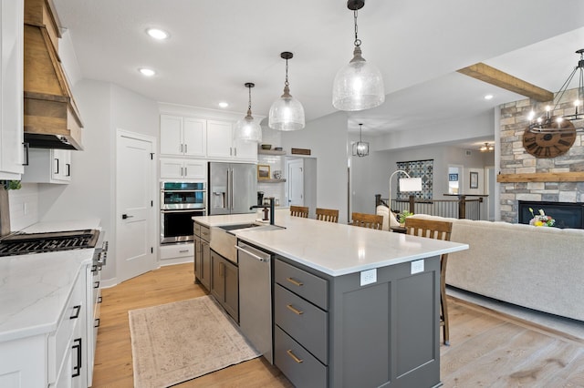 4452 167th Ave NW, Andover, MN 55304 - kitchen featuring appliances with stainless steel finishes, light wood-type flooring, white cabinetry, recessed lighting, and a breakfast bar area