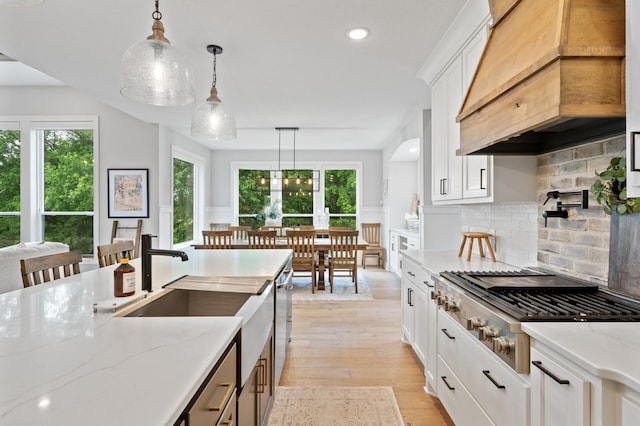 4452 167th Ave NW, Andover, MN 55304 - kitchen featuring custom exhaust hood, gas cooktop, healthy amount of natural light, tasteful backsplash, and recessed lighting