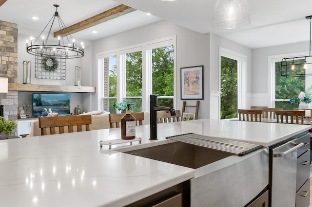 4452 167th Ave NW, Andover, MN 55304 - kitchen with a chandelier, light stone counters, plenty of natural light, pendant lighting, and beamed ceiling