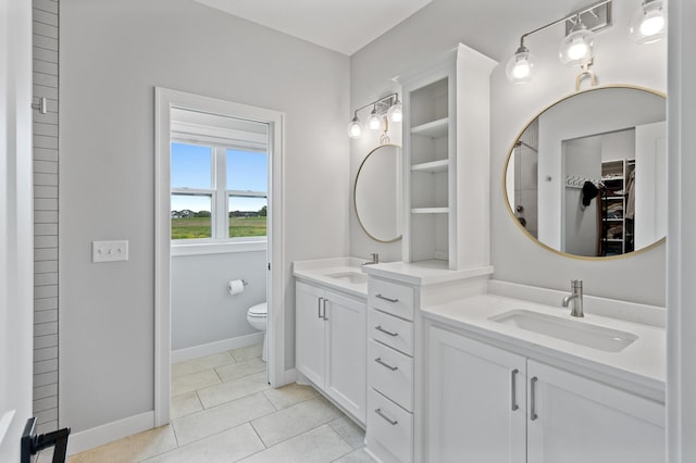 4452 167th Ave NW, Andover, MN 55304 - bathroom with double vanity, a spacious closet, and tile patterned flooring