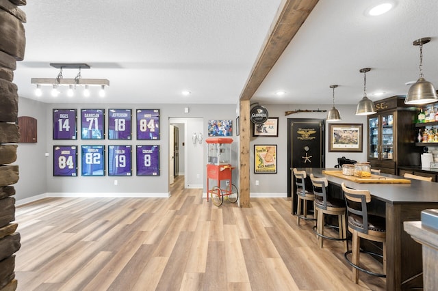 4452 167th Ave NW, Andover, MN 55304 - indoor bar with light wood-type flooring, hanging light fixtures, recessed lighting, and a textured ceiling