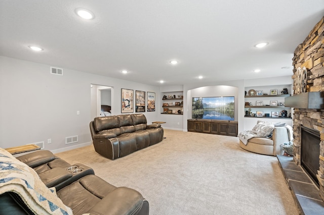 4452 167th Ave NW, Andover, MN 55304 - carpeted living room with a stone fireplace, recessed lighting, and built in shelves