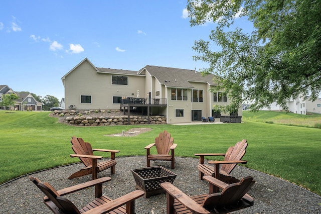 4452 167th Ave NW, Andover, MN 55304 - rear view of house featuring a fire pit, a patio area, a lawn, and a wooden deck