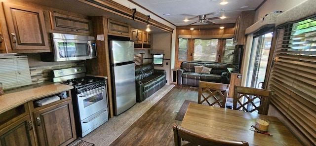 13240 Devils Lake Rd NW Unit 20, Brandon, MN 56315 - kitchen with stainless steel appliances, ceiling fan, dark wood-style flooring, tasteful backsplash, and light countertops