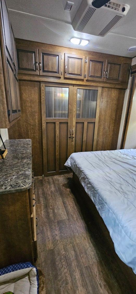 13240 Devils Lake Rd NW Unit 20, Brandon, MN 56315 - bedroom with dark wood-style floors and wood walls