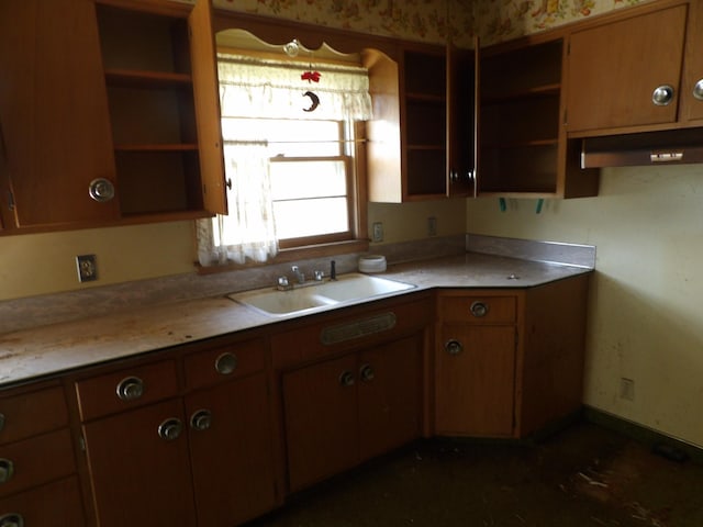 711 2nd Ave NW, Austin, MN 55912 - kitchen with open shelves, under cabinet range hood, light countertops, and brown cabinetry