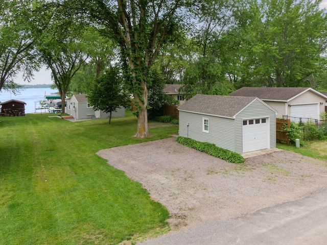 7315 120th St NW, Annandale, MN 55302 - view of yard featuring an outbuilding, driveway, a water view, and a garage