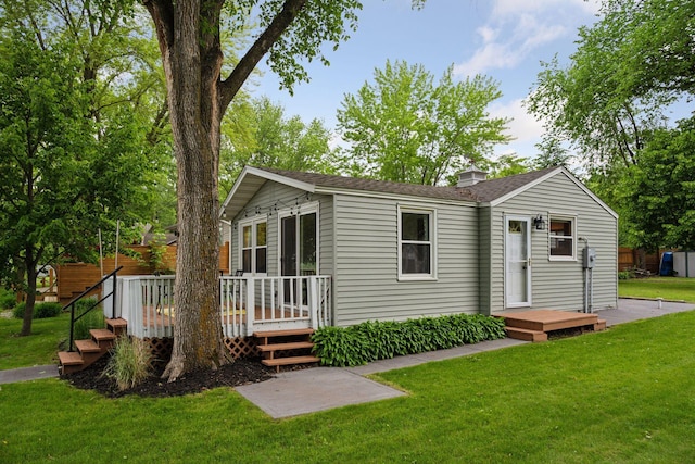 7315 120th St NW, Annandale, MN 55302 - view of front of house with a wooden deck, a front lawn, and a shingled roof