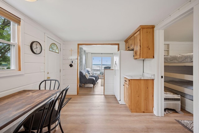 7315 120th St NW, Annandale, MN 55302 - kitchen with light wood-style floors, freestanding refrigerator, and light stone countertops