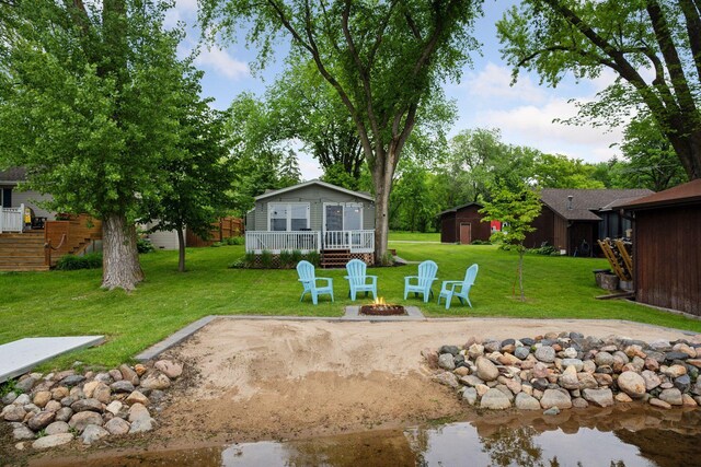 7315 120th St NW, Annandale, MN 55302 - view of green lawn featuring a fire pit and a wooden deck