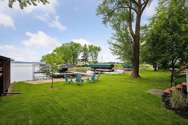 7315 120th St NW, Annandale, MN 55302 - view of green lawn featuring a water view, a dock, and boat lift