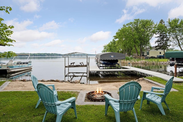 7315 120th St NW, Annandale, MN 55302 - dock area with boat lift, an outdoor fire pit, a water view, and a yard